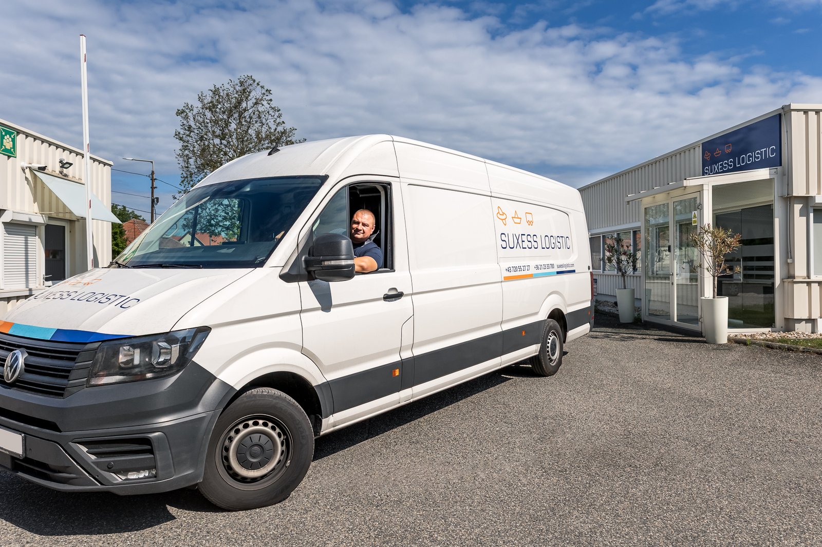 SUXESS LOGISTIC driver in the company's own van in front of the hub