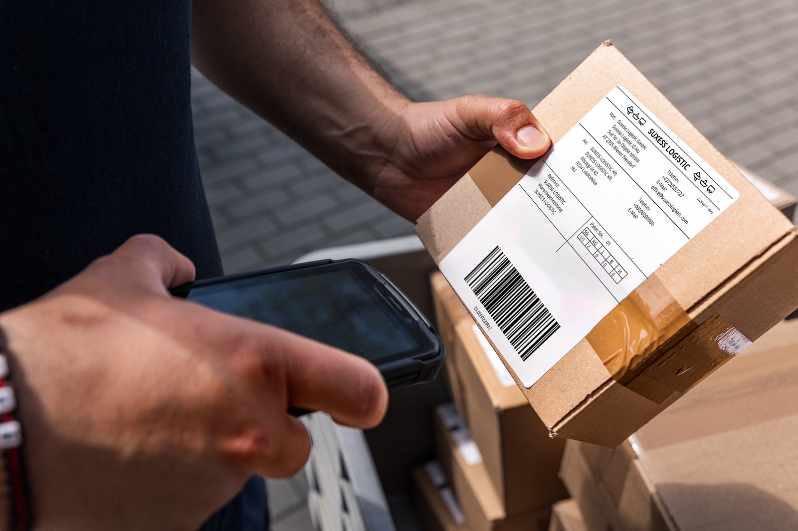 Parcel with a SUXESS LOGISTIC shipping label being scanned